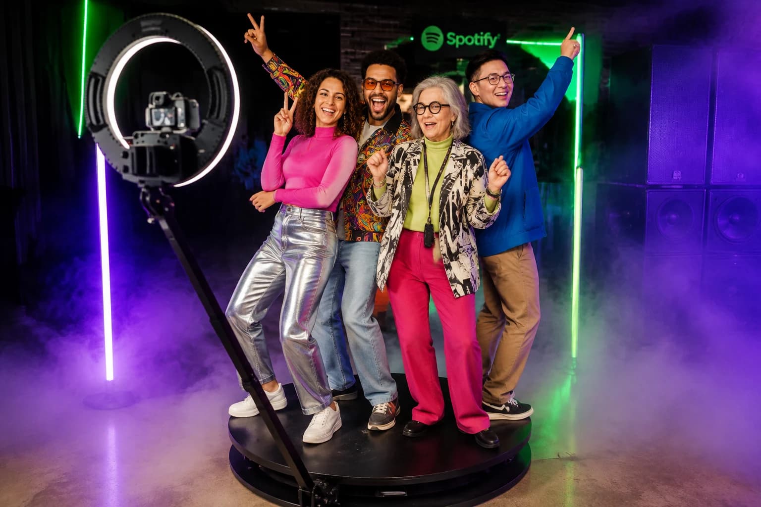 A diverse group dancing on a circular 360 booth platform at a music activation