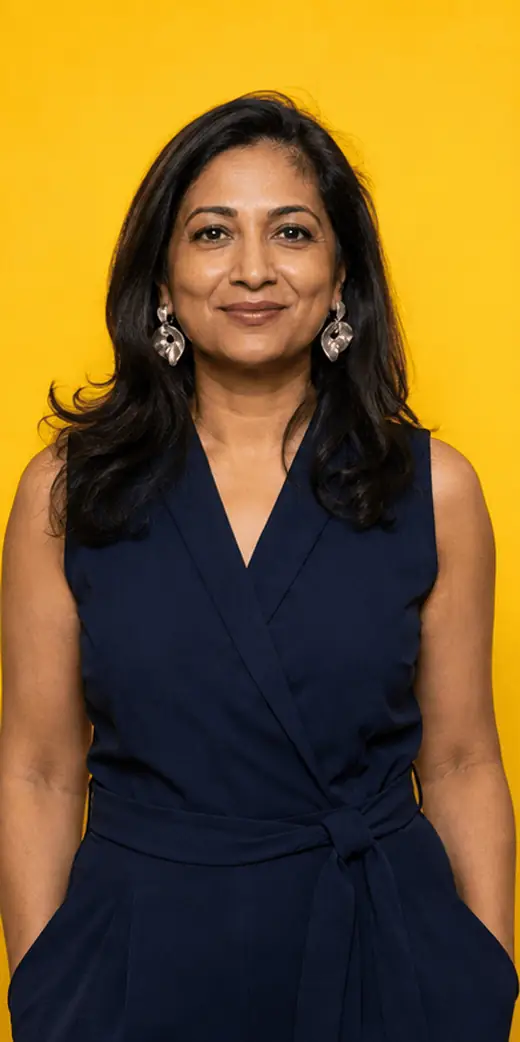 Animated GIF booth loop of a South Asian woman moving from composed to playful against a yellow backdrop